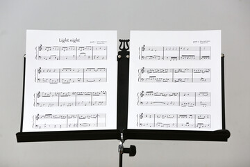 Poster - Note stand with music sheets on light background