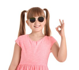 Wall Mural - Cute little girl with stylish sunglasses showing OK gesture on white background