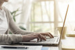 © StockPhotoPro - Woman sitting at desk and working with her laptop