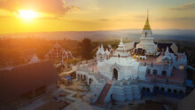 View Over The Temples Of Chaiyaphum In Thailand To The Surrounding Mountains At Sunset