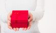 © sorapop - Valentine Day. Female beauty hands holding small gift package box present wrapped paper with ribbon isolated on white background, Christmas, New year, Birthday holiday background concept