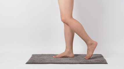 Wall Mural - Legs of male barefoot walking on soft carpet. with white background.isolated and copy space