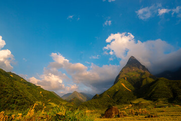 Beautiful landscape mountain green field grass meadow white cloud blue sky on sunny day. Majestic green scenery big mountain hill cloudscape valley panorama view in countryside greenery pasture