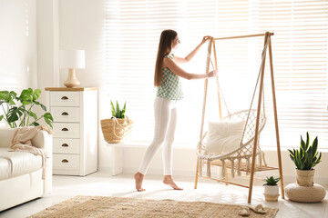 Poster - Woman near comfortable hammock chair at home