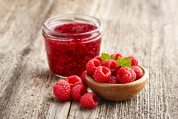 Canvas Print - Raspberry jam with berry on  wooden background