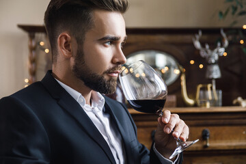 Wall Mural - Handsome bearded man with a glass of red wine