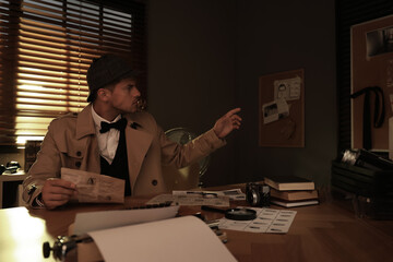 Wall Mural - Old fashioned detective working at table in office