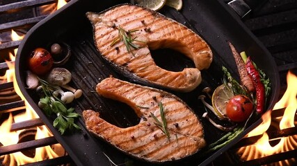 Wall Mural - Grilled salmon fish with various vegetables on pan on the flaming grill