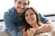 © opolja - Happy couple or marriage hugging and enjoying in a couch at home.
