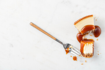 Wall Mural - Broken slice of cheesecake with caramel sauce. Eating cheesecake process