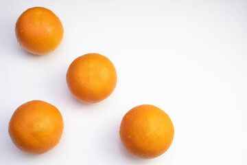 Wall Mural - four fresh oranges are spread out on a table