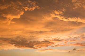 Wall Mural - golden sunset scenery with bright illuminated clouds, soft sky background
