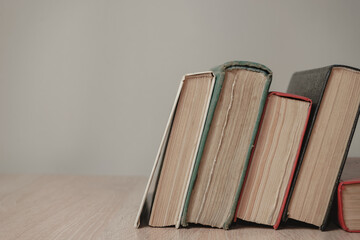 Beautiful vintage ancient books. Pattern background for design. The book on a wooden table and white wall background.