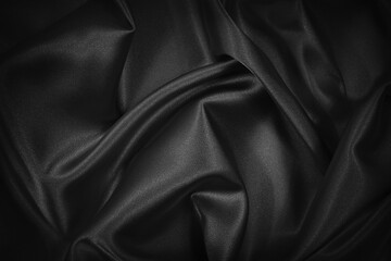Wall Mural - Black silk satin texture background. Beautiful wavy soft folds on shiny smooth fabric. Anniversary, event, card, invitation, concept. Black elegant background with copy space for design.