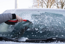 Someone Cleans The Windshield Of The Car From Ice