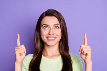 Wall Mural - photo portrait of pretty smiling girl pointing up at copyspace with fingers looking isolated on vivi