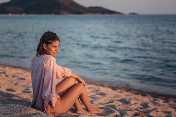 Young beautiful woman having fun at beach. Summer photo of young beautiful girl. Female on beach enjoying sea vacation traveling