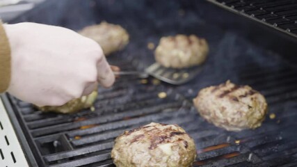 Sticker - Cooking hamburger beef patties on a gas grill.