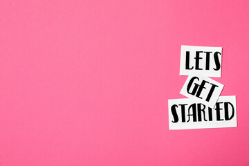 Poster - Sheets of paper with phrase Let's Get Started on pink background, flat lay. Space for text