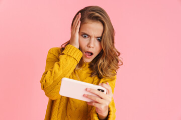 Wall Mural - Shocked beautiful blonde girl playing video game on cellphone