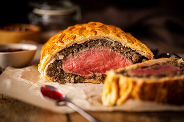 Perfect homemade juicy Beef Wellington, tenderloin dish on rustic wooden table