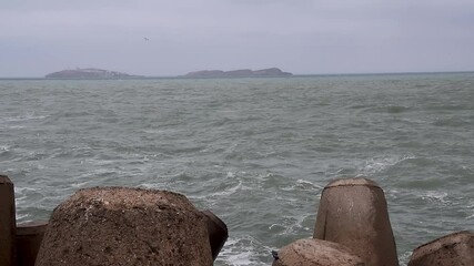 Wall Mural - Waves and rocks in  cloudy day