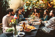 © Criene Images - group of adult friends at dinner garden party together having dinner