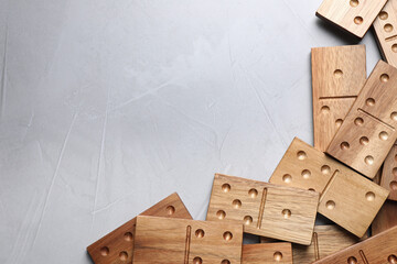 Poster - Wooden domino tiles on grey table, flat lay. Space for text