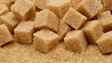 Brown Sugar Cubes Close Up. Demerara Golden Brown Sugar