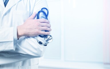 Sticker - Young man doctor holding a stethoscope on background