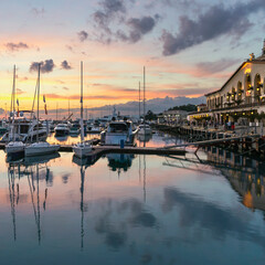 Wall Mural - small sailboats in the harbor of the Sochi seaport against the background of the sea station