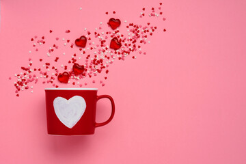 Red cup mug with with painted heart, sugar and chocolate hearts on pink background. Flat lay composition. Valentines Day concept. Top view, copy space.