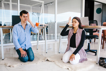 Wall Mural - latin business people meditating and doing yoga in office in Mexico city