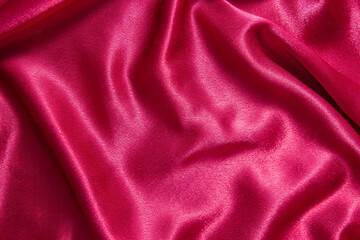 red crepe satin fabric with folds - abstract background