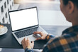 © panitan - computer screen blank mockup.hand woman work using laptop with white background for advertising,contact business search information on desk at coffee shop.marketing and creative design