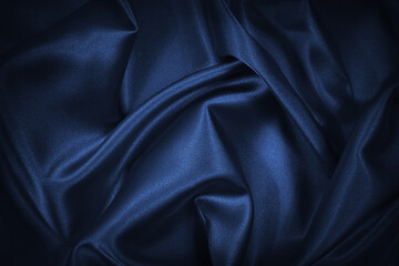 Wall Mural - Abstract blue black background. Navy blue silk satin texture background. Beautiful soft wavy folds on shiny fabric. Dark elegant background for your design.