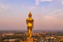 Beautiful Golden Buddha Statue Standing On A Mountain Wat Phra That Khao Noi, Nan Province, Thailand.