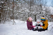 © Evgenia Tiplyashina - Three children on a walk in winter, a teenager