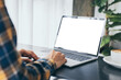 © panitan - computer screen blank mockup.hand woman work using laptop with white background for advertising,contact business search information on desk at coffee shop.marketing and creative design
