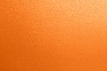 Texture of orange leather as background, top view