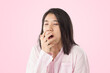 © SoftSheep - young asian woman wear pink pajamas yawn feeling sleepy