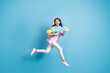 Full body profile photo of crazy carefree lady look empty space hold pump water pistol isolated on blue color background