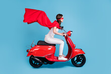 Full Length Profile Photo Of Attractive Hero Lady Drive Moped Wear White Outfit Red Cloak Mask Isolated On Blue Color Background
