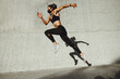 © Jacob Lund - Fitness woman sprinting wearing face mask