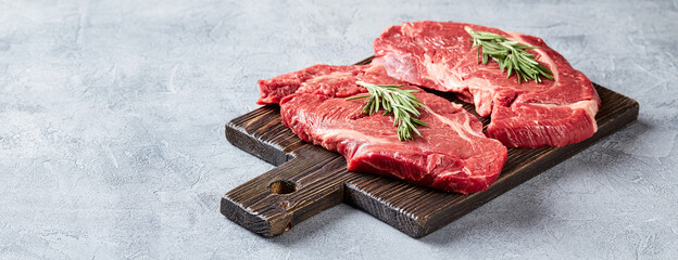 Wall Mural - Two Fresh Raw meat Prime Black Angus Beef Steaks, Rib Eye, Denver, on wooden cutting board