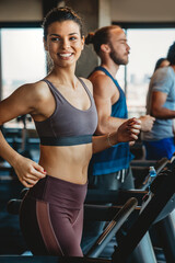 Wall Mural - Group of young people running on treadmills in sport gym