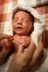 Mother holding little baby wrapped in towel after bath. High quality photo