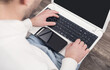 © andranik123 - Man using laptop at home.