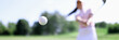 © H_Ko - Golf ball against background of hitting woman closeup. Active healthy lifestyle concept