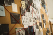 © New Africa - Detective board with crime scene photos, stickers, clues and red thread, closeup